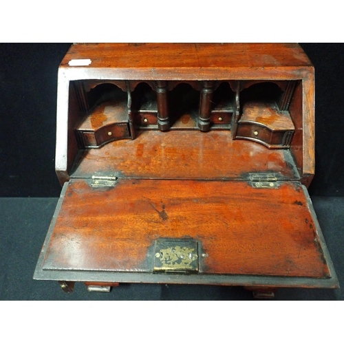 213 - AN EARLY 18th CENTURY STYLE MAHOGANY MINIATURE BUREAU fall front with fully fitted interior, three l... 