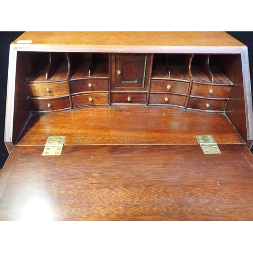 217 - AN 18th CENTURY STYLE MAHOGANY MINIATURE BUREAU fall front with fully fitted interior, two short and... 