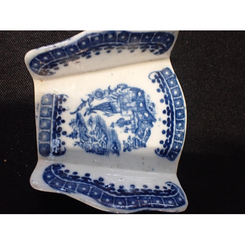 277 - A PEARLWARE TEA STRAINER, IN THE FORM OF A CHINESE SPOON and a transfer printed asparagus holder (2)