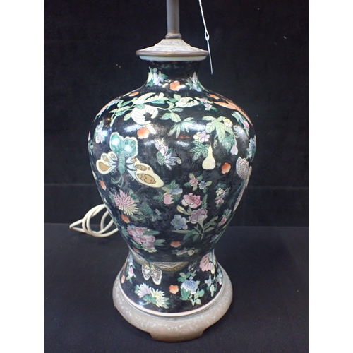 297 - A CHINESE PORCELAIN BALUSTER TABLE LAMP enamelled insects and flowers on a black ground 44cm high pl... 