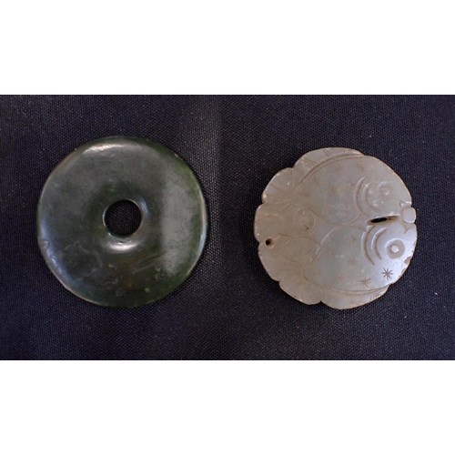 303 - A JADE BI DISC CARVED WITH TWO FISH with another dark green plain bi disc