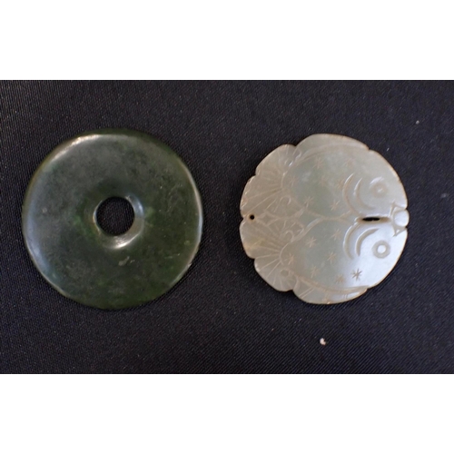 303 - A JADE BI DISC CARVED WITH TWO FISH with another dark green plain bi disc