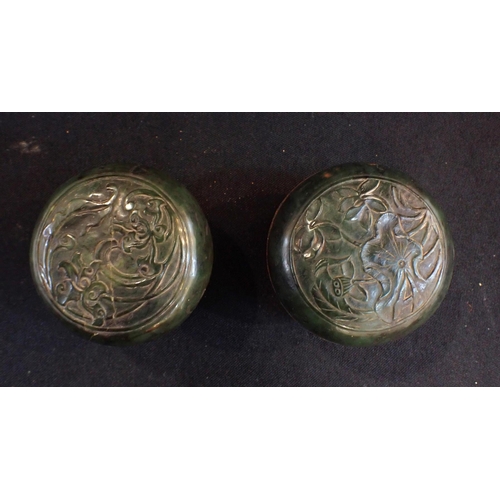 306 - A PAIR OF CHINESE CARVED STONE COCERED POTS with hardwood stands, with old labels and (ink?) content... 