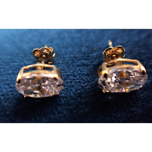 425 - A PAIR OF OVAL CUT CUBIC ZIRCONIA STUD EARRINGS in 9ct yellow gold, 6x8mm in diameter, stamped 9K, (... 