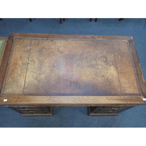 783 - AN OAK PEDESTAL DESK, WITH SWAN-NECK BRASS HANDLES and worn leather top, mid 20th century 122cm wide... 