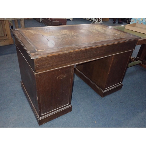 783 - AN OAK PEDESTAL DESK, WITH SWAN-NECK BRASS HANDLES and worn leather top, mid 20th century 122cm wide... 