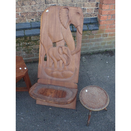 813 - AN AFRICAN TEAK CHAIR, CARVED WITH ELEPHANTS an Indian teak and brass occasional table, and a teak c... 