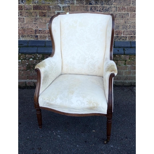 816 - A 19TH CENTURY MAHOGANY WINGBACK ARMCHAIR with moulded frame, serpentine seat, and slender reeded le... 