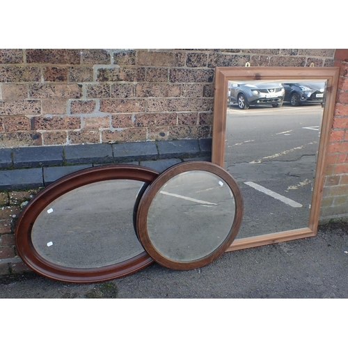 821 - A PINE-FRAMED MIRROR 104 x 74cm, an oval mirror, and a round mirror (3)