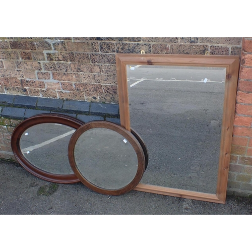 821 - A PINE-FRAMED MIRROR 104 x 74cm, an oval mirror, and a round mirror (3)