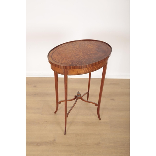 10 - A SATINWOOD OCCASIONAL TABLE BY MAPLE &  CO

bearing label to the underside, the ebony strung oval t... 