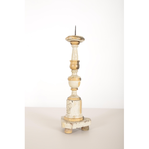 19 - THREE  ITALIAN WHITE-PAINTED AND PARCEL GILT PRICKET CANDLESTICKS

carved and gilded with fluted col... 