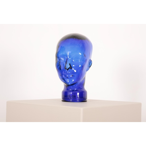 8 - A MOULDED BLUE GLASS MANNEQUIN HEAD

29cm high, a blue glass bottle shaped vase, 26cm high, and a Sp... 