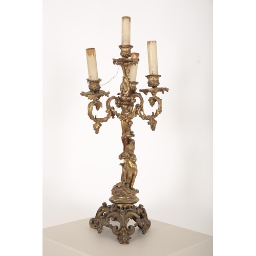 105 - A GILT BRONZE CANDLEABRA

19th century, of Bacchanalian theme with a rococo scrolling base rising to... 