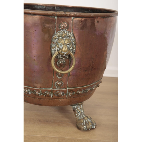 108 - A COPPER AND BRASS MOUNTED LOG BIN

19th century, with two lions head handles, on paw feet, 45cm hig... 