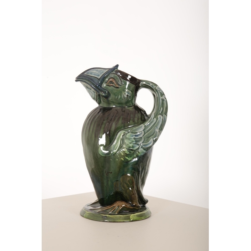 111 - C. H. BRANNAM: A BARUM ART POTTERY 'GROTESQUE BIRD' JUG

majolica glazed in green and blue, modelled... 