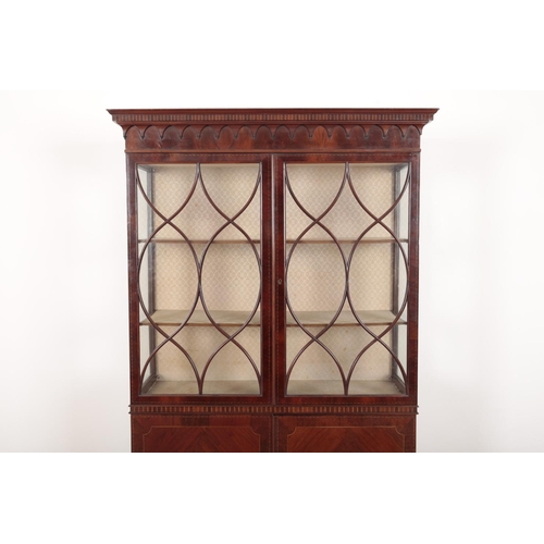 123 - AN EDWARDIAN MAHOGANY AND SATINWOOD STRUNG DISPLAY CABINET

with a moulded cornice over glazed cupbo... 