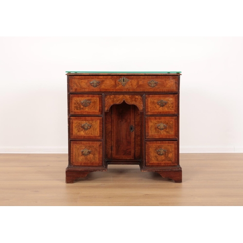 126 - A GEORGE IIII FIGURED WALNUT KNEEHOLE DESK

with feather and cross banding, with an arrangement of s... 