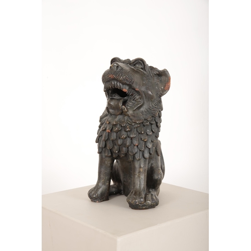 129 - AN ASIAN OVERPAINTED BLACK TERRACOTTA LION

probably early 20th Century, with open jaws and lolling ... 