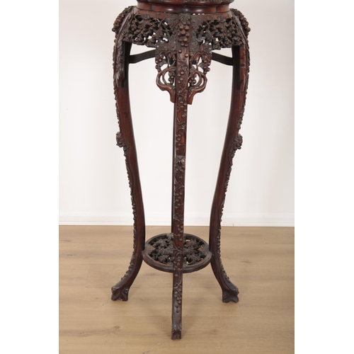 130 - A CHINESE EXPORT HARDWOOD CARVED JARDINIERE STAND

19th century, with a profusion of scrolling vines... 