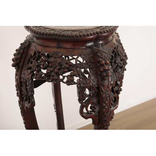 130 - A CHINESE EXPORT HARDWOOD CARVED JARDINIERE STAND

19th century, with a profusion of scrolling vines... 