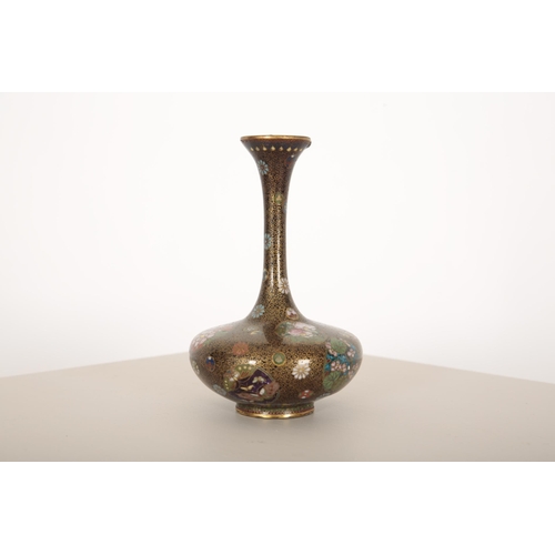 138 - A CHINESE CLOISONNÉ ENAMEL VASE

with slender neck, floral filled and alternate colour roundels on a... 