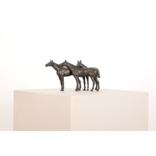 140 - A DARK BROWN PATINATED BRONZE OF THREE BRIDLED HORSES

20th century, gathered closely together their... 