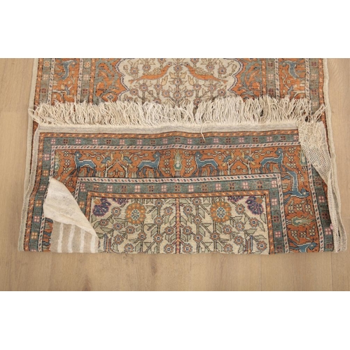 142 - A TURKISH PRAYER RUG

woven in muted colours and orange with birds and trees on a cream ground, with... 