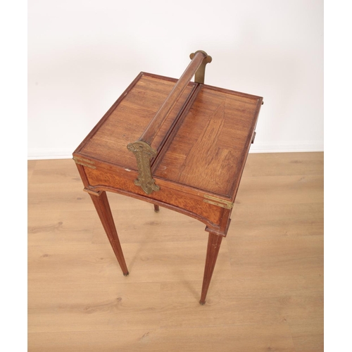 149 - AN EDWARDIAN MARQUETRY WORK TABLE

the moulded handle arm on cast gilt metal mounts, above a top inl... 