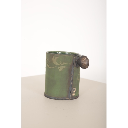 162 - *SARAH DUNSTAN (b. 1969) FOR GAOLYARD STUDIOS: A GREEN JUG

the body with overlaid porcelain decorat... 