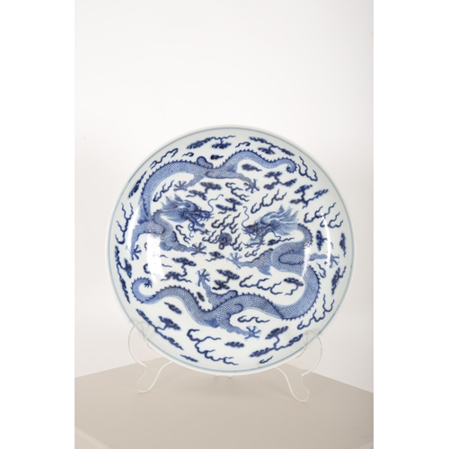 181 - A CHINESE BLUE AND WHITE DRAGON DISH

decorated with five-claw dragons contesting flaming pearls ami... 