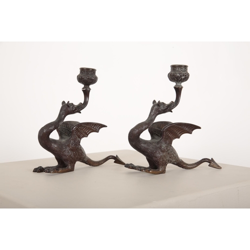 184 - A PAIR OF WINGED MYTHOLOGICAL BEAST BRONZE CANDLESTICKS

20th century, the candle bowl issuing from ... 