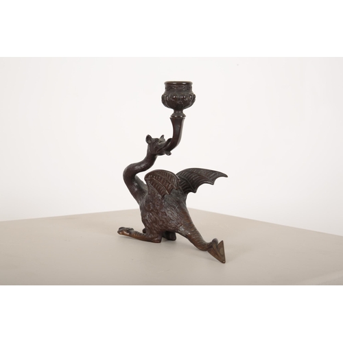 184 - A PAIR OF WINGED MYTHOLOGICAL BEAST BRONZE CANDLESTICKS

20th century, the candle bowl issuing from ... 