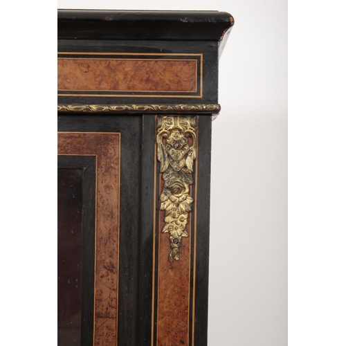 198 - A VICTORIAN EBONISED AND WALNUT BOOKCASE

with glazed doors opening to a shelved interior, on turned... 