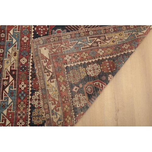 201 - AN ANTIQUE KAZAK RUG

woven in white, pale blue and red with geometric ornament and flower heads on ... 