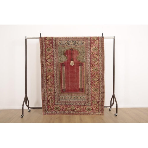 214 - AN ANTIQUE TURKISH PRAYER RUG

woven in pale colours and mustard with hanging lantern and columns on... 