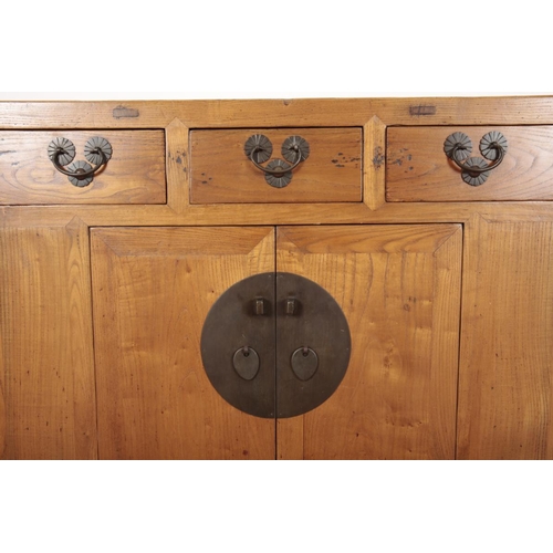 217 - A CHINESE ELM SIDE CABINET

20th century, with three short drawers over a cupboard, opening to a she... 