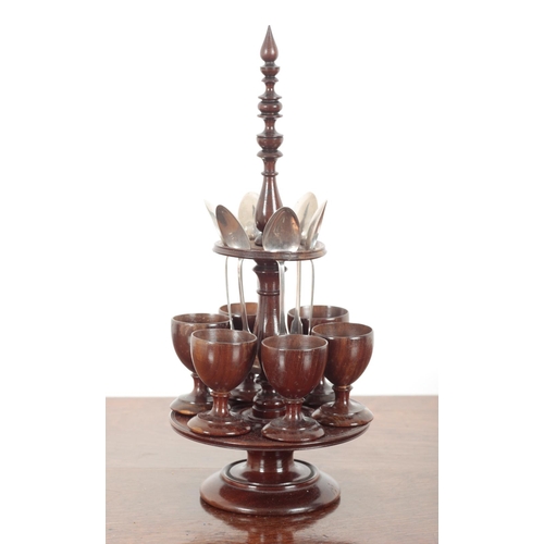 218 - A TURNED WOOD EGG CRUET

early 19th century, formed on a central baluster column and two circular ti... 