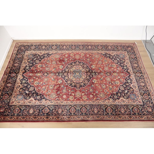 285 - A CENTRAL PERSIAN KASHAN CARPET

the central floral medallion against a brick red ground with blue s... 