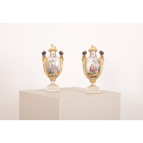 46 - A PAIR OF 'HELENA WOLFSOHN' STYLE PORCELAIN TWO HANDLED URNS

late 19th century, the covers with bud... 