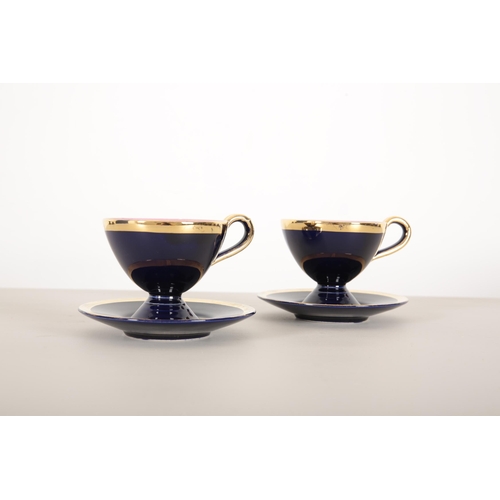 70 - A VALLAURIS DARK BLUE AND GILT TEA SERVICE

1950's, with pink interior, consisting of eight cups and... 