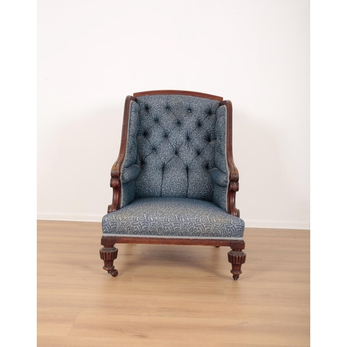 72 - A MAHOGANY WINGBACK ARMCHAIR

19th century, with button back floral pattern covers, the carved crest... 