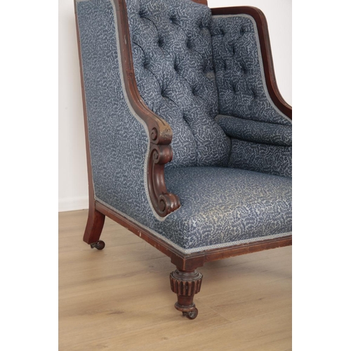 72 - A MAHOGANY WINGBACK ARMCHAIR

19th century, with button back floral pattern covers, the carved crest... 