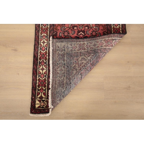 80 - A NORTH WEST PERSIAN MALAYER RUNNER

with a central floral medallion against a brick red ground, wit... 