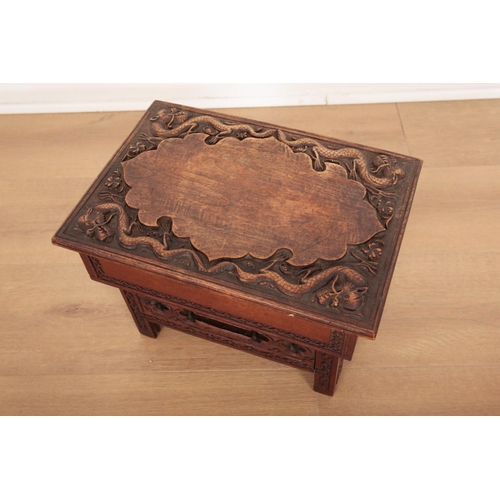 96 - A CHINESE CARVED AND STAINED WOOD LOW FOLDING TABLE

the top carved in relief with dragons, the side... 