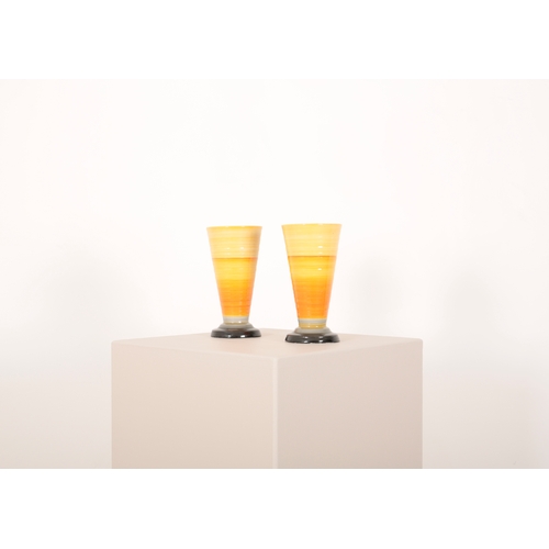 88a - A PAIR OF SHELLEY POTTERY CONICAL VASES the ribbed bodies decorated in yellow, orange, grey and blac... 