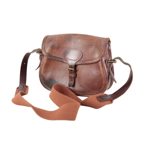 223 - A BROWN LEATHER CARTRIDGE BAG

with canvas and leather shoulder strap, for approx. 100 cartridges