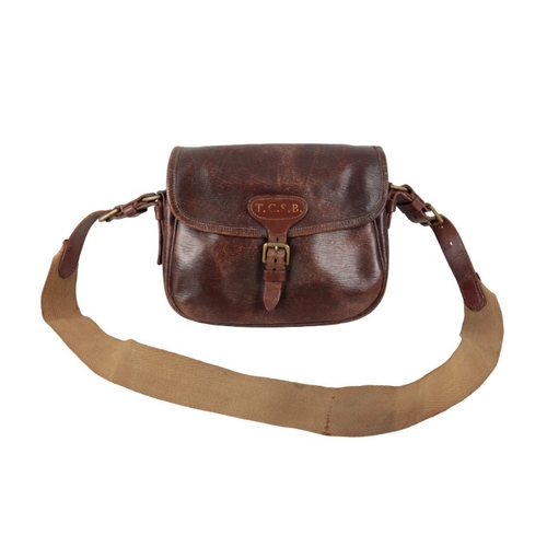 227 - A BROWN LEATHER CARTRIDGE BAG

with a canvas and leather shoulder strap, for approx. 100 cartridges