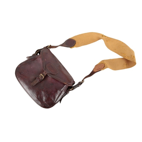 229 - A BROWN LEATHER CARTRIDGE BAG

with a canvas and leather shoulder strap, for approx. 100 cartridges