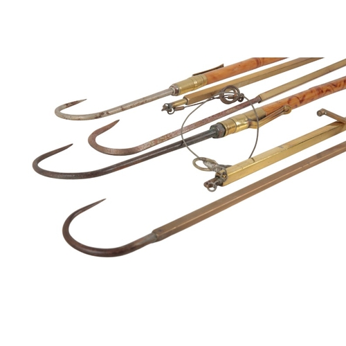 27 - HARDY BROS: A BRASS FISH TAILER

together with one other brass fish tailer; and four vintage fishing... 